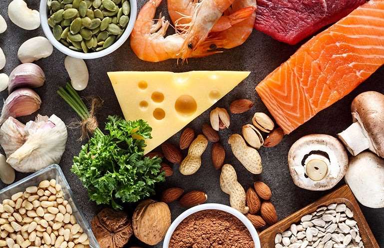A table with fish, cheese, and other food high in zinc.