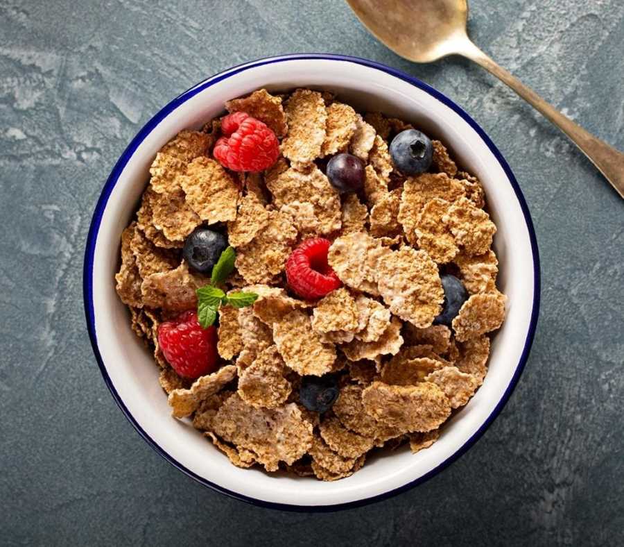Bowl of bran cereal and fruit in bowl.