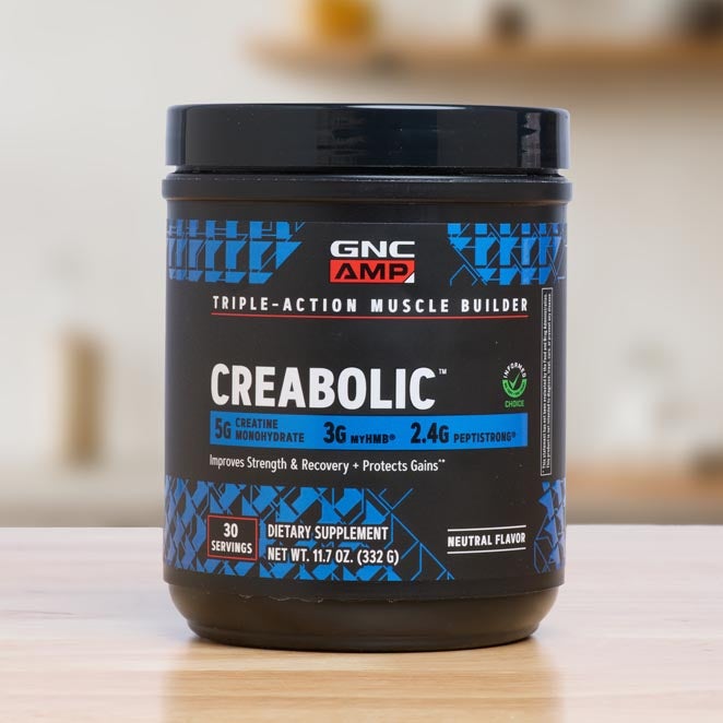 GNC Creabolic supplement tub sitting on counter.