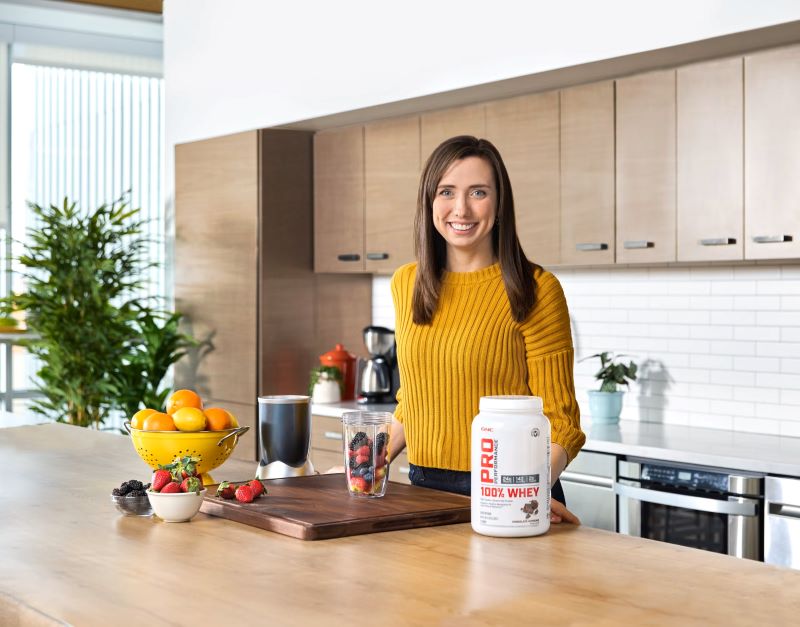 Mary Milstead at counter with fruit and blender.