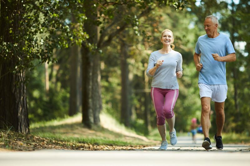 Man and woman outside, jogging together.