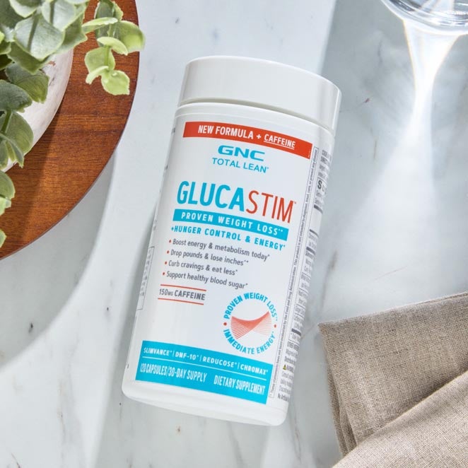 White, teal and orange bottle of GlucaStim, on marble counter.