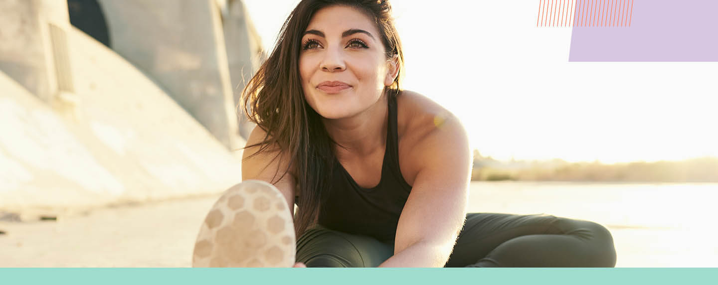 Woman Sitting on the Ground Stretching