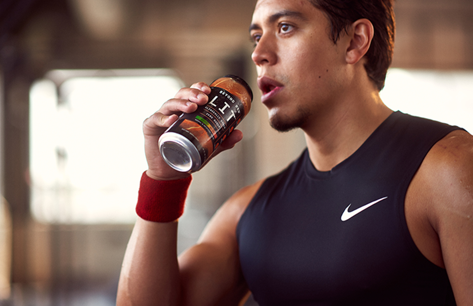 man drinking a pre-mixed beyond raw lit pre-workout drink