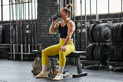 Woman on bench with dumbbells