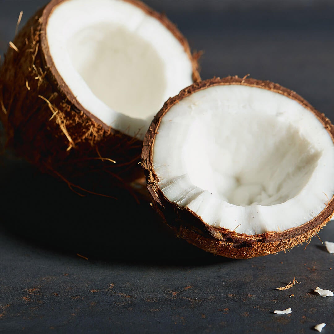 A coconut similar to the ones used to source Macros MCT oil is split in