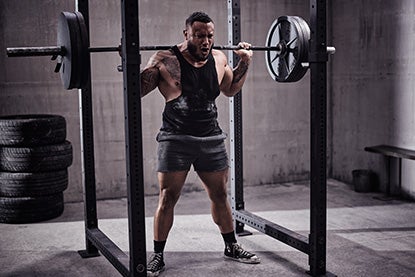 Man Barbell Back Squatting